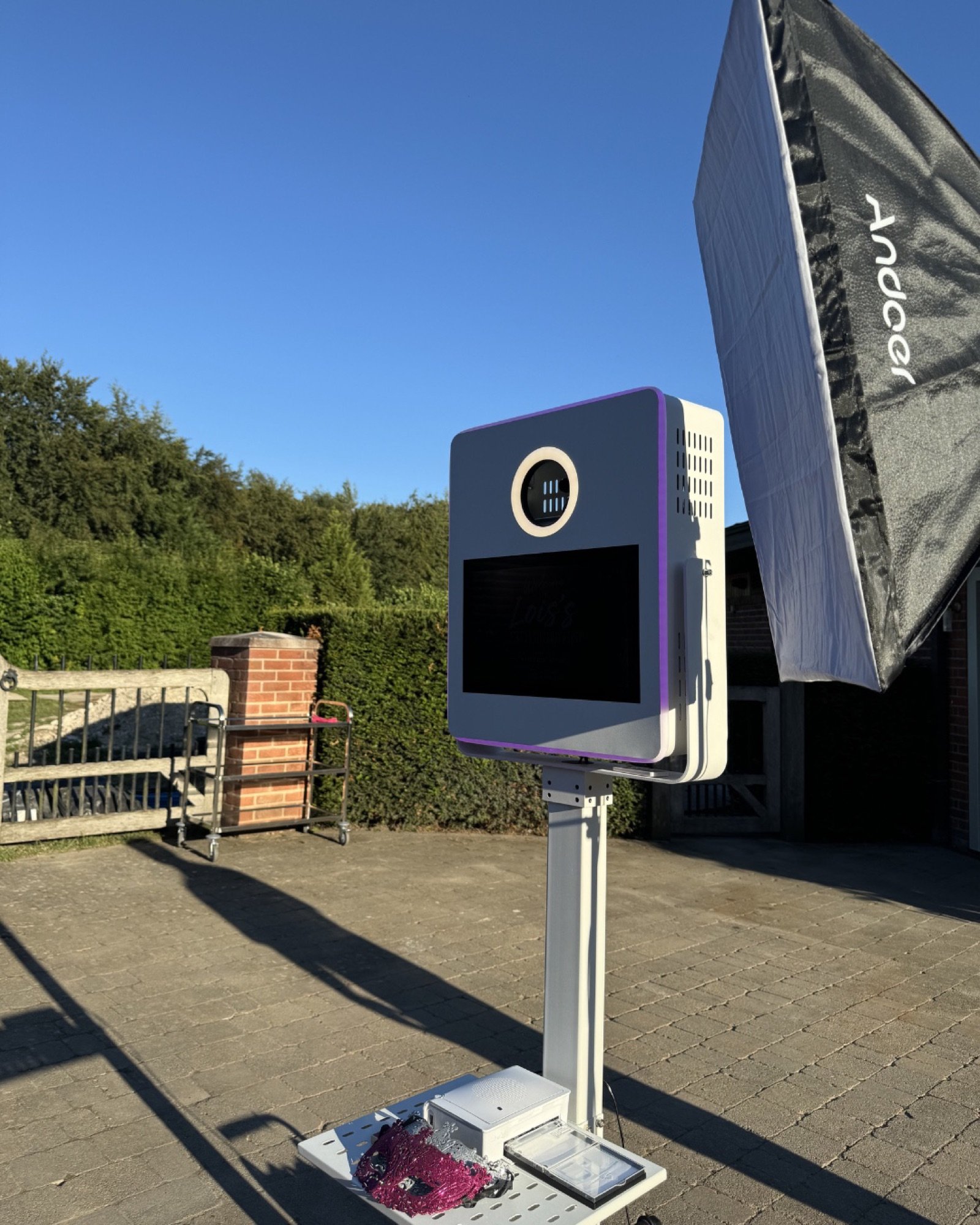 The PhotoGenieBooths mirror booth set up outdoors with studio lighting