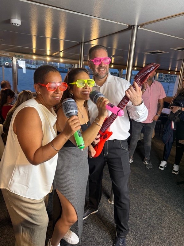 Guests laughing with inflatable party props on a boat party photo booth